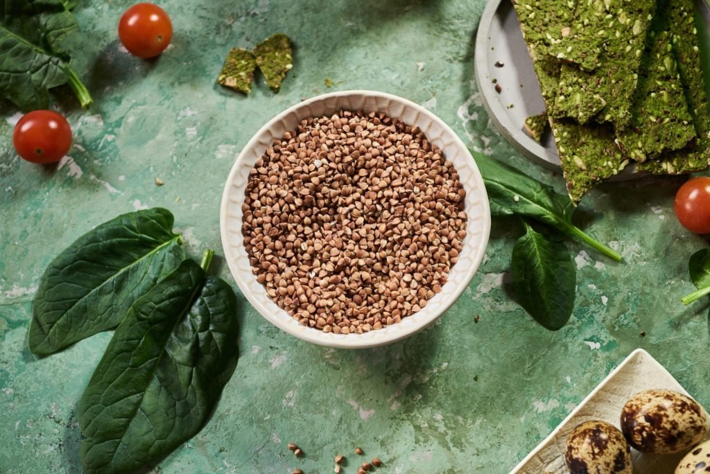 Roasted buckwheat on green background. Nutrition and benefits.