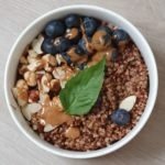 berry breakfast porridge with roasted buckwheat and nut butter